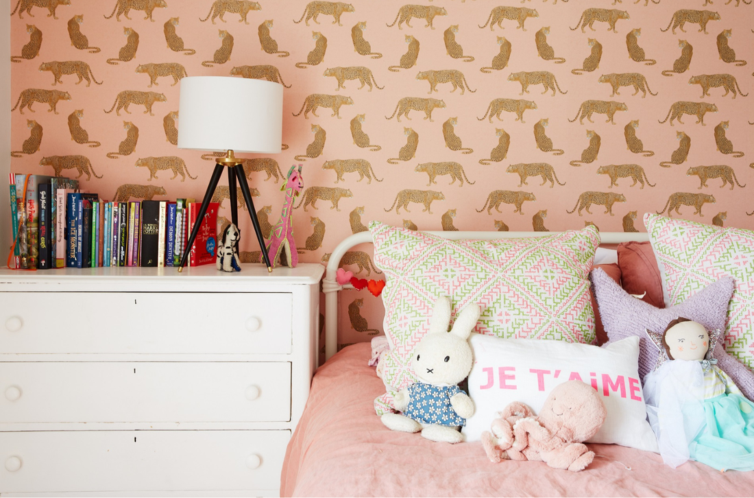 A bedroom with leopard print wallpaper