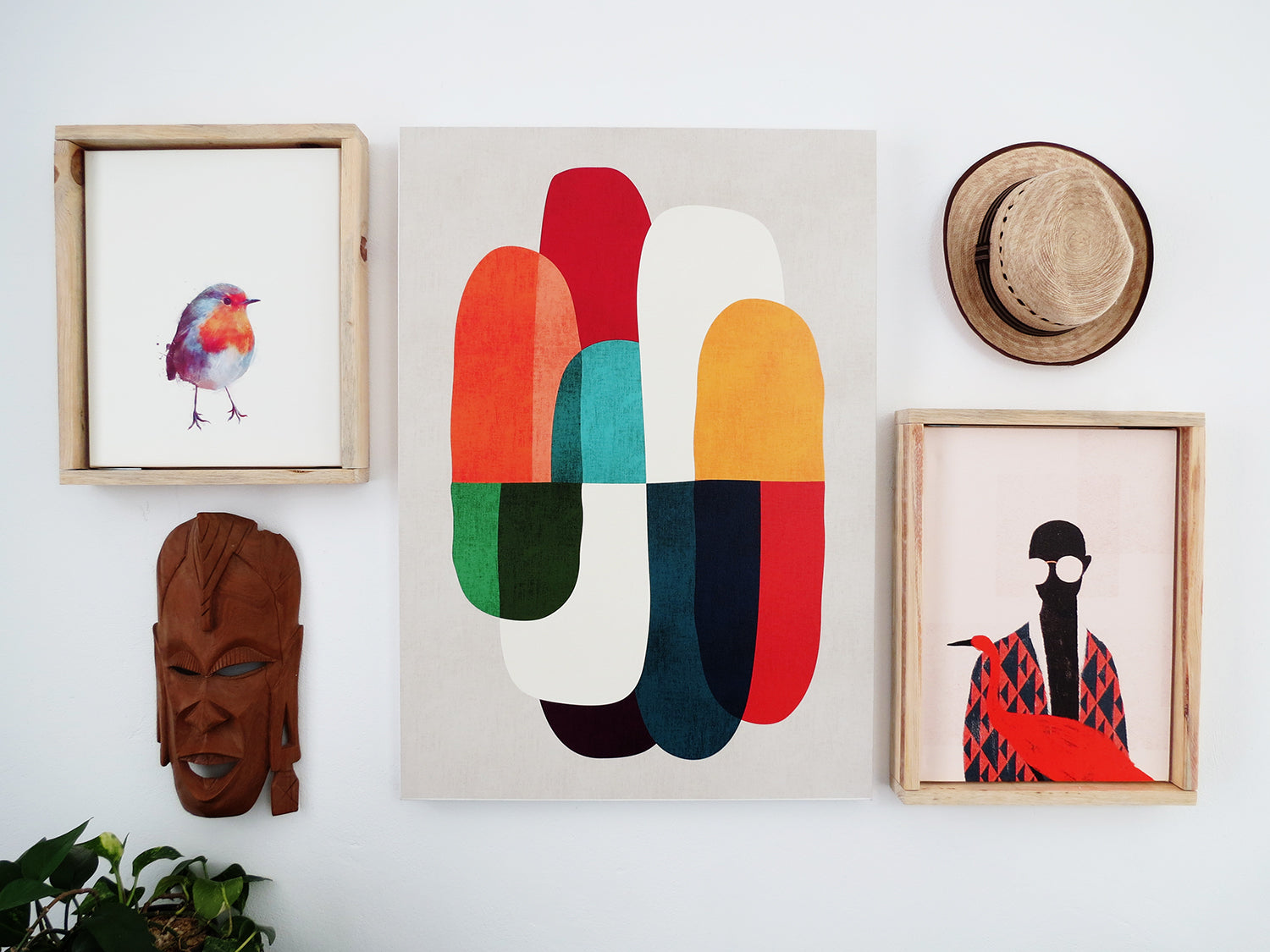 artworks on a white wall with floating frames