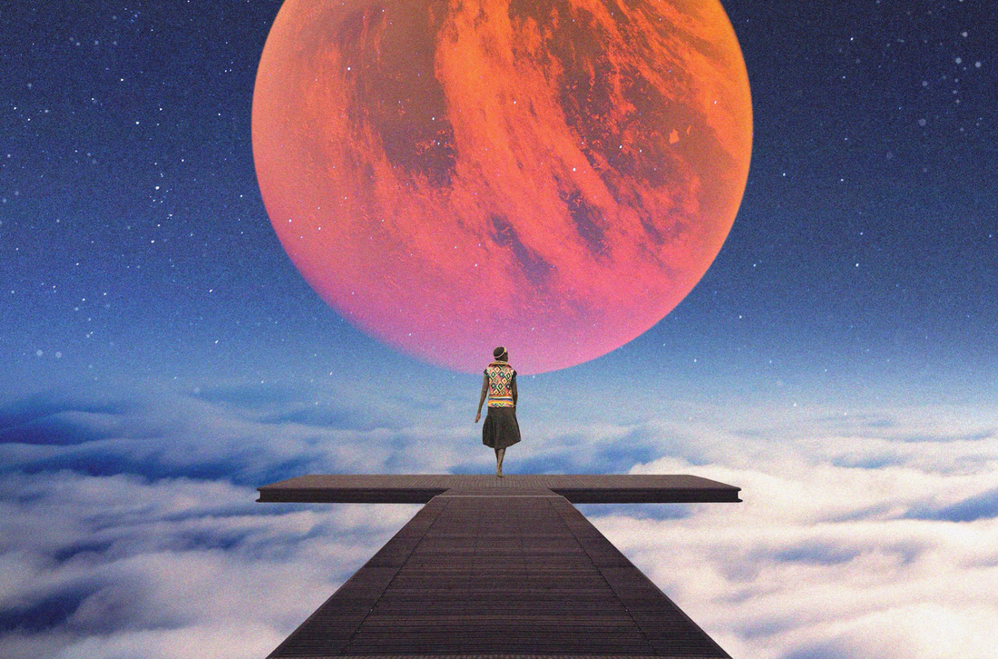 A person walking down a pier towards a planet