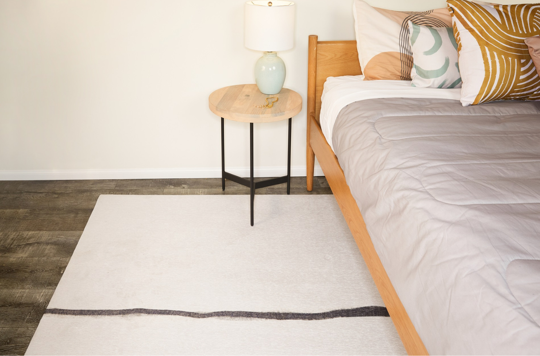 A bedroom with an area rug