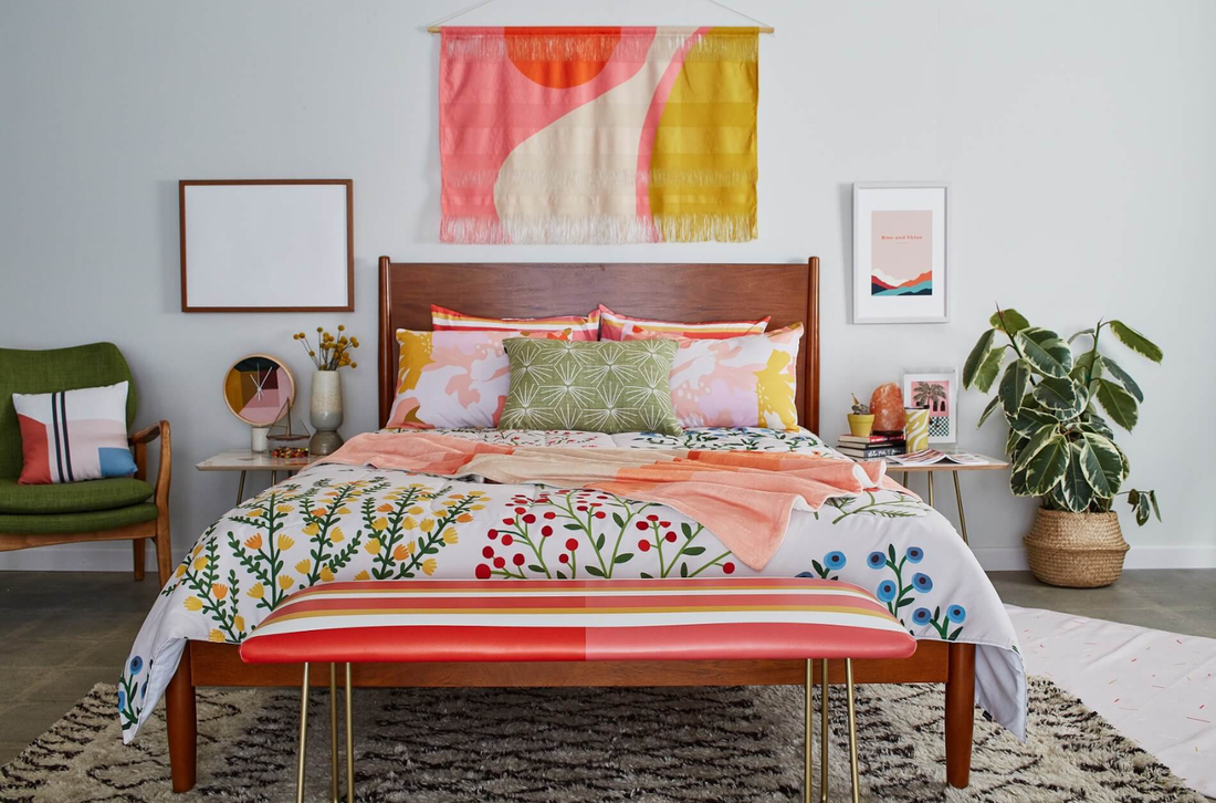 A decorated bedroom styled with a throw blanket