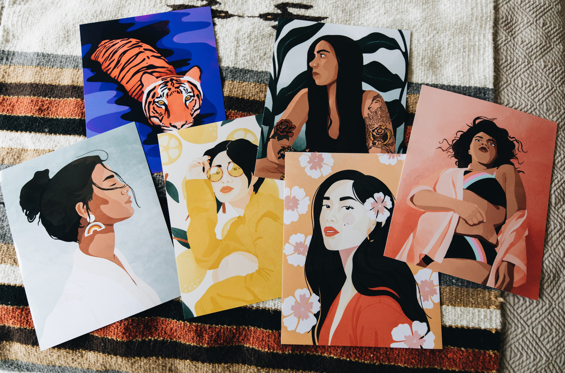 Art prints spread out on a bed