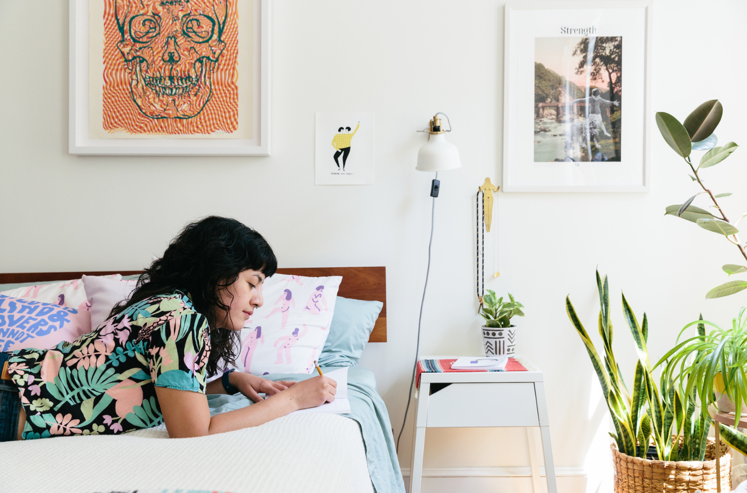 A person making notes on their bed