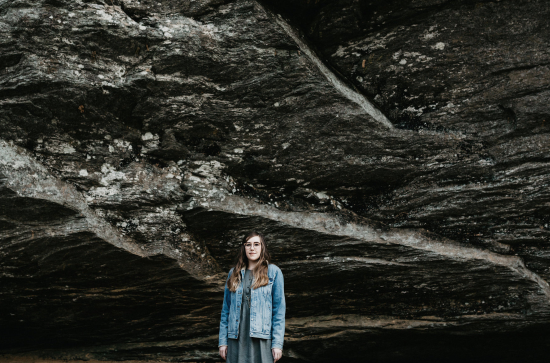 Jessica Roux standing in front of a cliff side