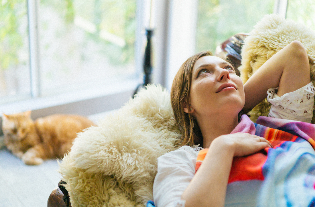 Elena Kulikova laying on a couch