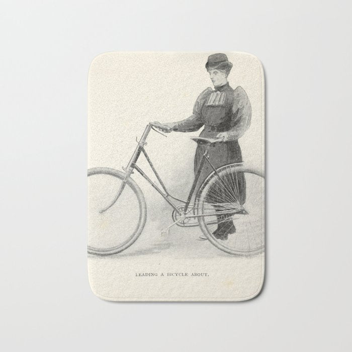 "Leading a Bicycle About" from "Bicycling for Ladies" by Maria E. Ward, 1896 Bath Mat Gallery Image 1