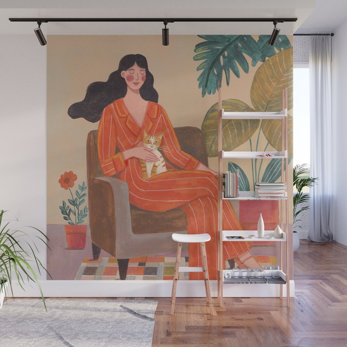 Woman with cat in living room in warm earth tones Wall Mural Gallery Image 1