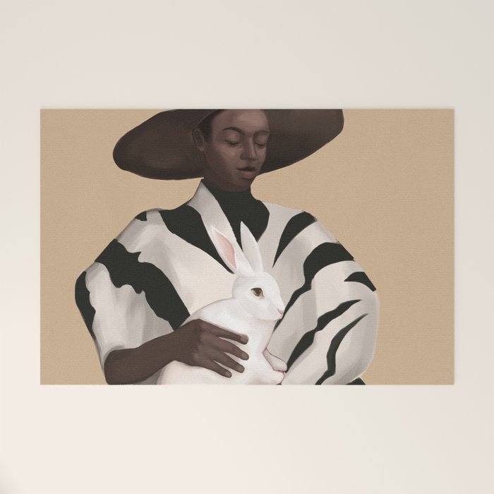 Woman in Stripes Holding a White Rabbit Welcome Mat Gallery Image 1