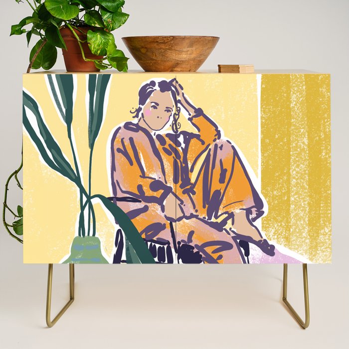 Woman wearing yellow pajamas Credenza Gallery Image 1