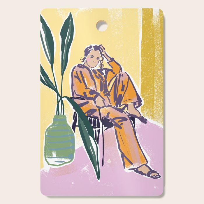 Woman wearing yellow pajamas Cutting Board Gallery Image 1