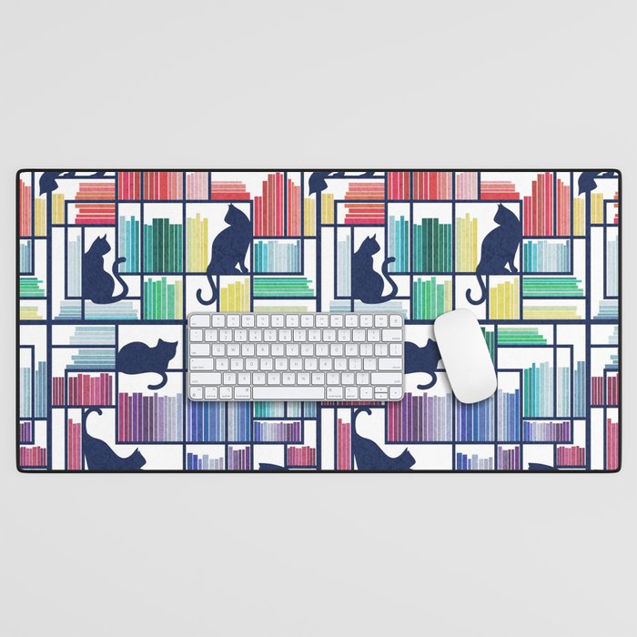 Rainbow bookshelf // white background navy blue shelf and library cats Desk Mat Gallery Image 1