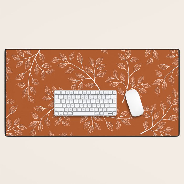 Delicate White Leaves and Branch on a Rust Orange Background Desk Mat Gallery Image 1