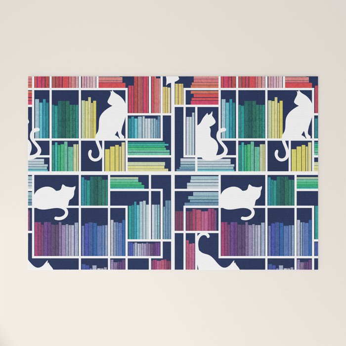 Rainbow bookshelf // navy blue background white shelf and library cats Welcome Mat