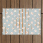 Peach flowers on green and orange vertical stripes background pattern Outdoor Rug Gallery Image 1