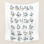 Dinosaur alphabet in muted shades of blue, grey and green Wall Tapestry Gallery Image 4