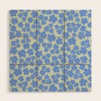 Blue flower blossom scatter on soft green Wood Wall Art Gallery Image 1