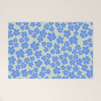 Blue flower blossom scatter on soft green Welcome Mat Gallery Image 1
