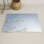 Wild radish flowers in a meadow in the spring against a clear blue sky - nature photography Rug Gallery Image 1