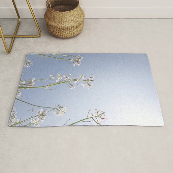 Wild radish flowers in a meadow in the spring against a clear blue sky - nature photography Rug Gallery Image 1