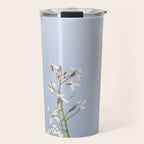 Wild radish flowers in a meadow in the spring against a clear blue sky - nature photography Travel Mug Gallery Image 1