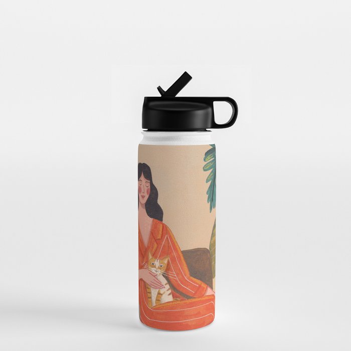 Woman with cat in living room in warm earth tones Water Bottle Gallery Image 1