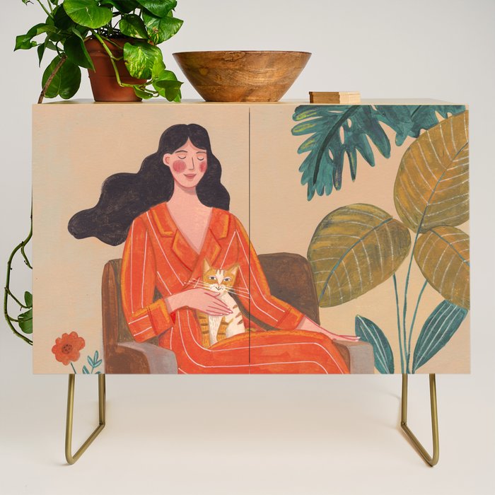 Woman with cat in living room in warm earth tones Credenza Gallery Image 1