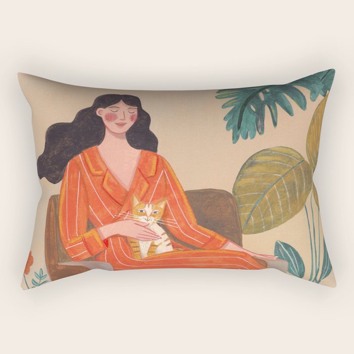 Woman with cat in living room in warm earth tones Rectangular Pillow Gallery Image 1