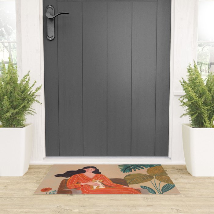 Woman with cat in living room in warm earth tones Welcome Mat Gallery Image 3