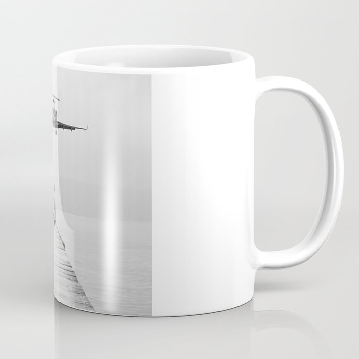 Steady As She Goes 6; aircraft coming in for an island landing female in bikini black and white photography - photographs - photograph Coffee Mug Gallery Image 1