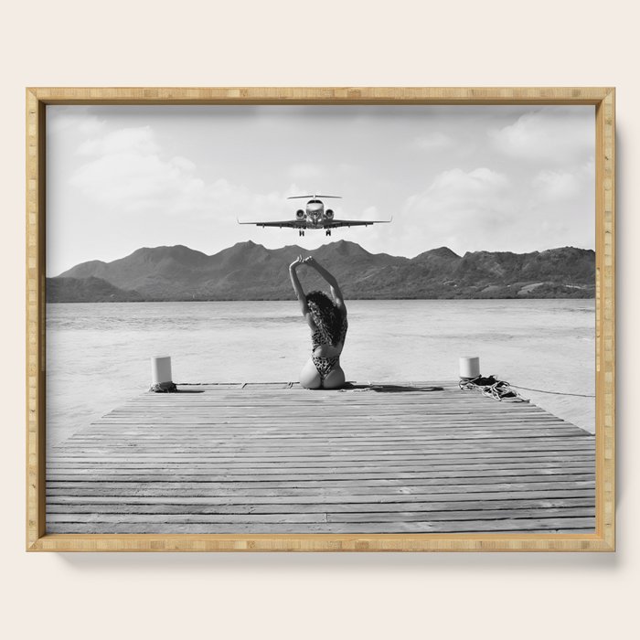 Steady as she goes girl in bikini on a dock with plane landing black and white photograph Serving Tray Gallery Image 1
