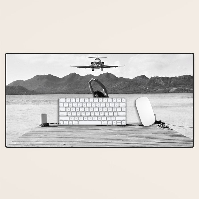 Steady as she goes girl in bikini on a dock with plane landing black and white photograph Desk Mat Gallery Image 1