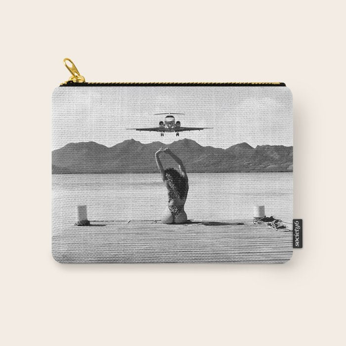 Steady as she goes girl in bikini on a dock with plane landing black and white photograph Carry All Pouch Gallery Image 1