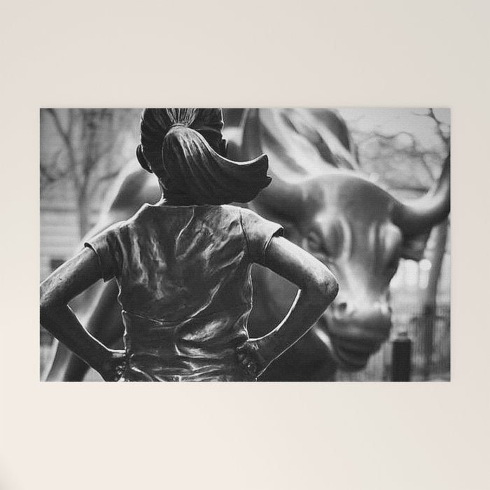 Fearless Girl facing down the Charging Bull statue of Wall Street black and white photography Welcome Mat Gallery Image 1