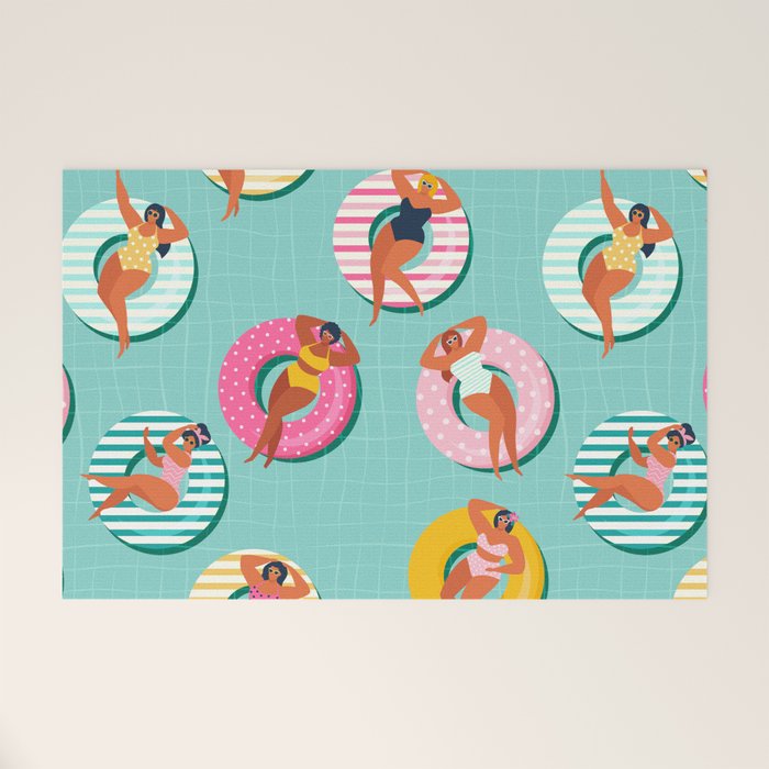 Summer gils on inflatable in swimming pool floats. Welcome Mat Gallery Image 1