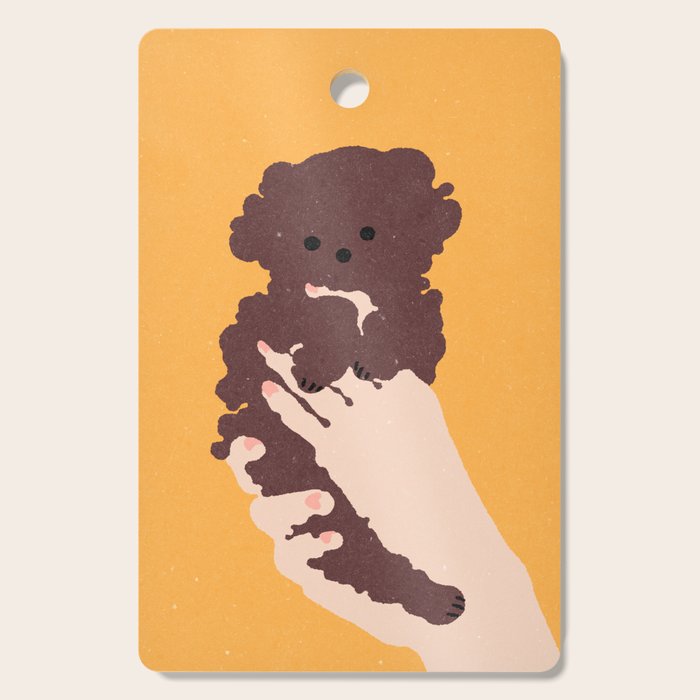 Cute puppy in arms Cutting Board Gallery Image 1
