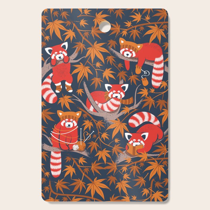 Red panda blending with the foliage // navy background red cozy animals fog brown taupe tree branches orange acer leaves Cutting Board Gallery Image 1