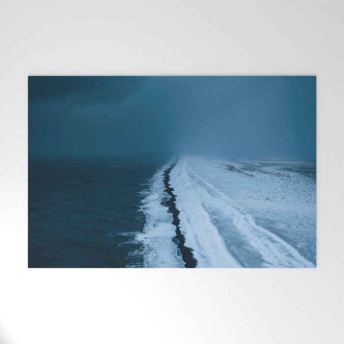 Black Sand Beach with snow in Iceland during a storm â Moody Landscape Photography Welcome Mat Gallery Image 1