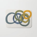Minimalist Mid Century Modern Colorful Rings Navy Blue Yellow Olive Green Spirals by Ejaaz Haniff Bath Mat Gallery Image 1