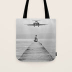 Steady As She Goes 6; aircraft coming in for an island landing female in bikini black and white photography - photographs - photograph Tote Bag Gallery Image 1