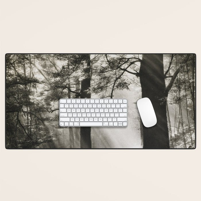 Pathway of light, sunlight and sunbeams in forest black and white photograph by J W Chapman Taylor Desk Mat Gallery Image 1