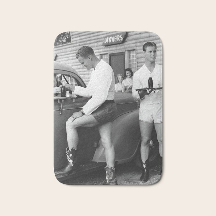 Texas love, male drive-in car hops in shorts and cowboy boots at drive in tavern near Love Field Airport in Dallas vintage black and white photograph - photography - photographs Bath Mat Gallery Image 1