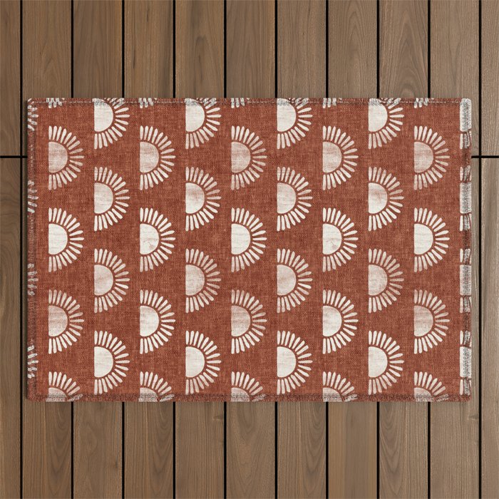 block print suns on rust Outdoor Rug Gallery Image 1