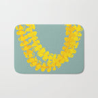 Puakenikeni lei drape on blue Bath Mat Gallery Image 1