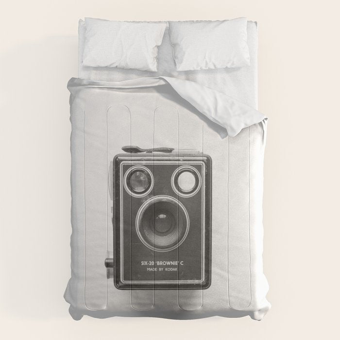 A Kodak Brownie analog vintage camera on a white background  Retro photography in black and white Comforter Gallery Image 1