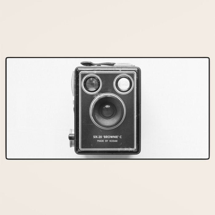 A Kodak Brownie analog vintage camera on a white background  Retro photography in black and white Desk Mat Gallery Image 3