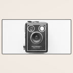 A Kodak Brownie analog vintage camera on a white background  Retro photography in black and white Desk Mat Gallery Image 3