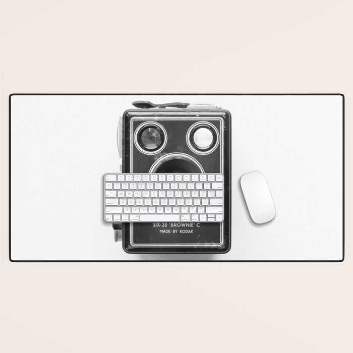 A Kodak Brownie analog vintage camera on a white background  Retro photography in black and white Desk Mat Gallery Image 1