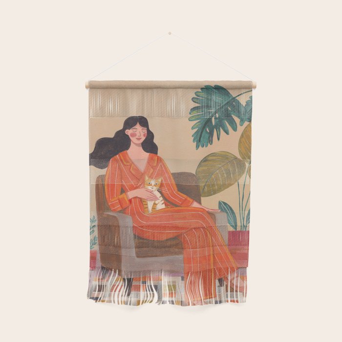 Woman with cat in living room in warm earth tones Wall Hanging Gallery Image 1