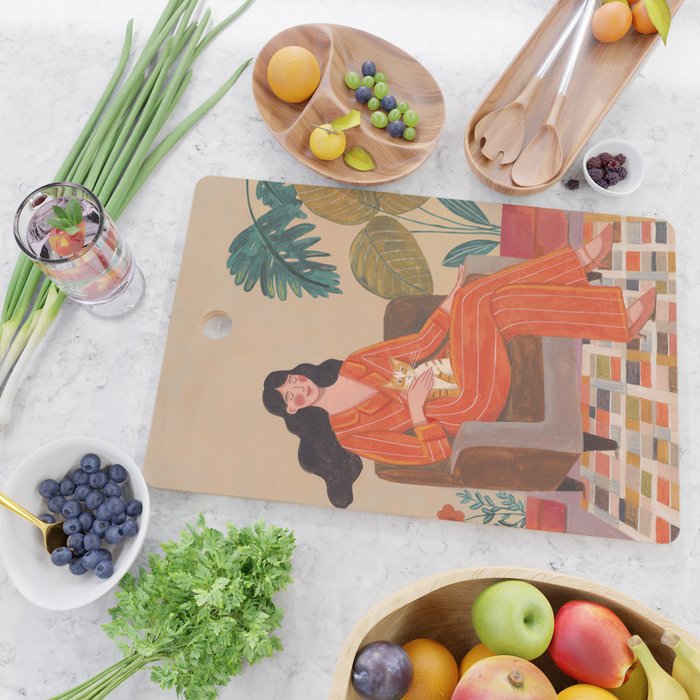 Woman with cat in living room in warm earth tones Cutting Board Gallery Image 2