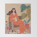 Woman with cat in living room in warm earth tones Throw Blanket Gallery Image 2